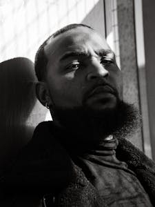Artistic black and white portrait of a man in Atlanta casting shadows.