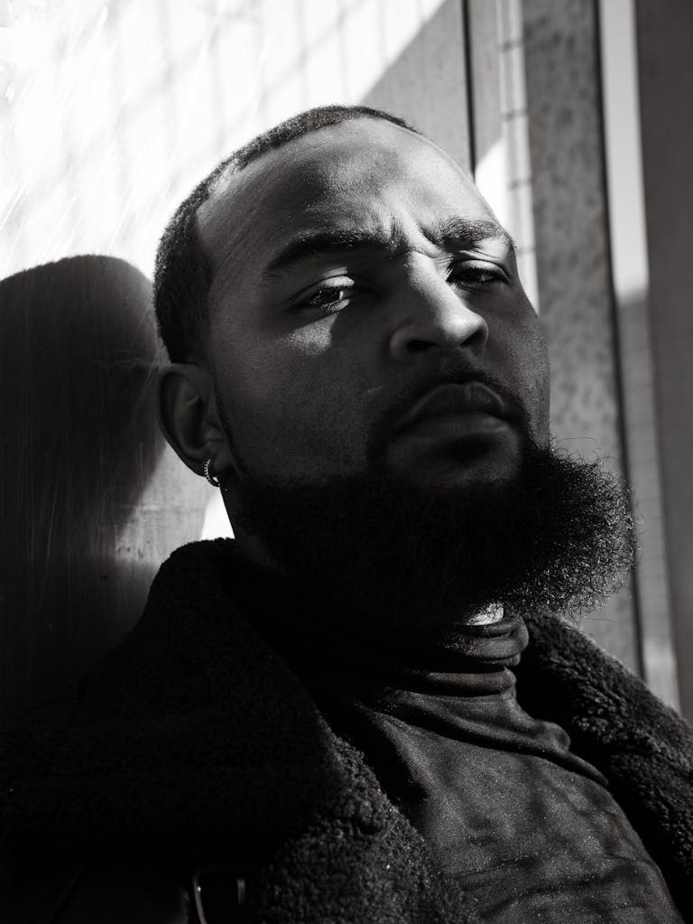 Artistic black and white portrait of a man in Atlanta casting shadows.