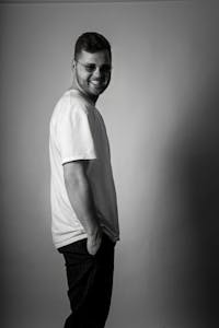 Monochrome portrait of a smiling man in casual attire. Stylish and timeless.