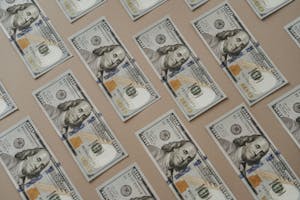 Close-up of multiple US dollar bills arranged in a grid pattern.