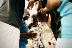 Group of boys enjoying a soccer game outdoors in Lagos, Nigeria. Monkey Post.